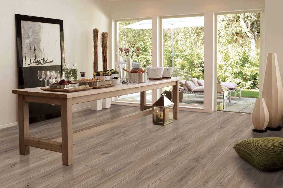 medium toned wood look floor in dining area with sliding pocket doors to outdoor patio